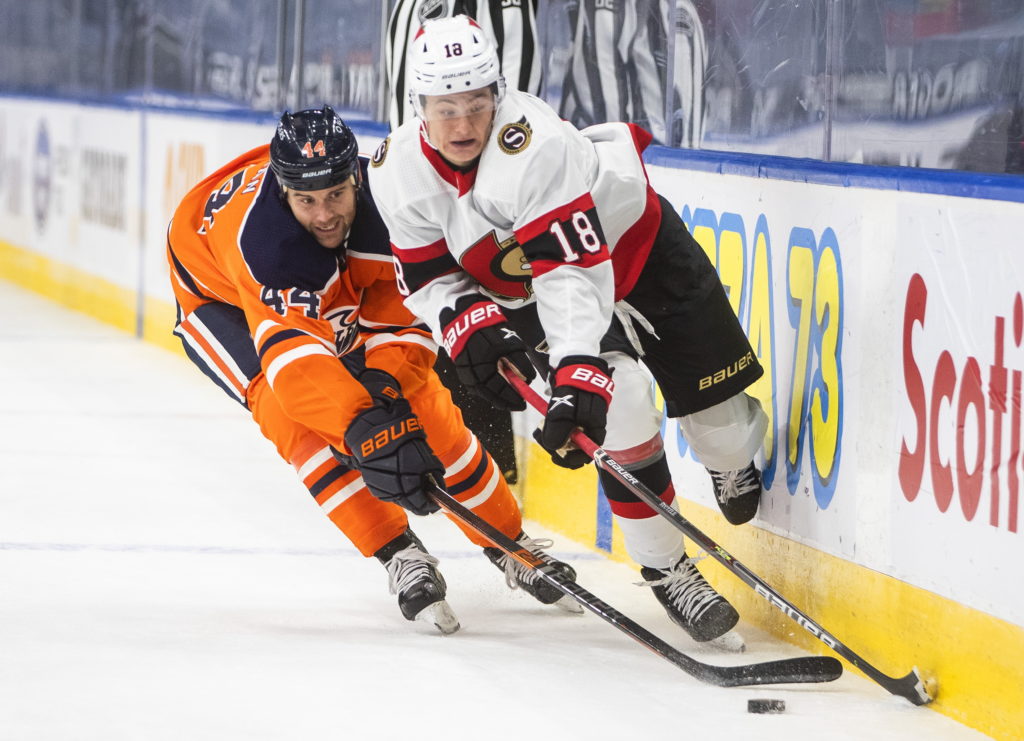 2 people playing hockey.