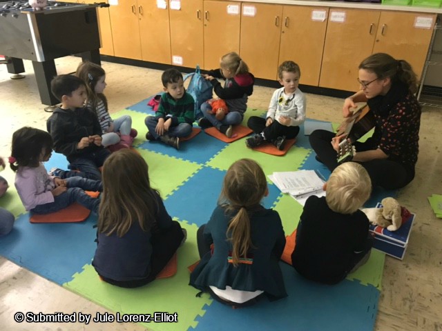 Kids singing with their teacher